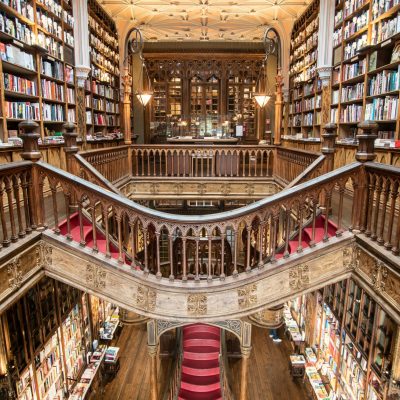 Stunning view of the iconic Livraria Lello's grand staircase and bookshelves in Porto, Portugal.